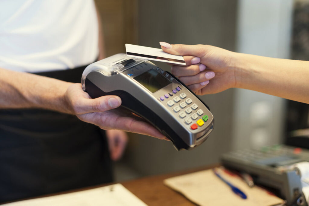 Card payment transaction at retail counter representing one-time payment models in Malaysia