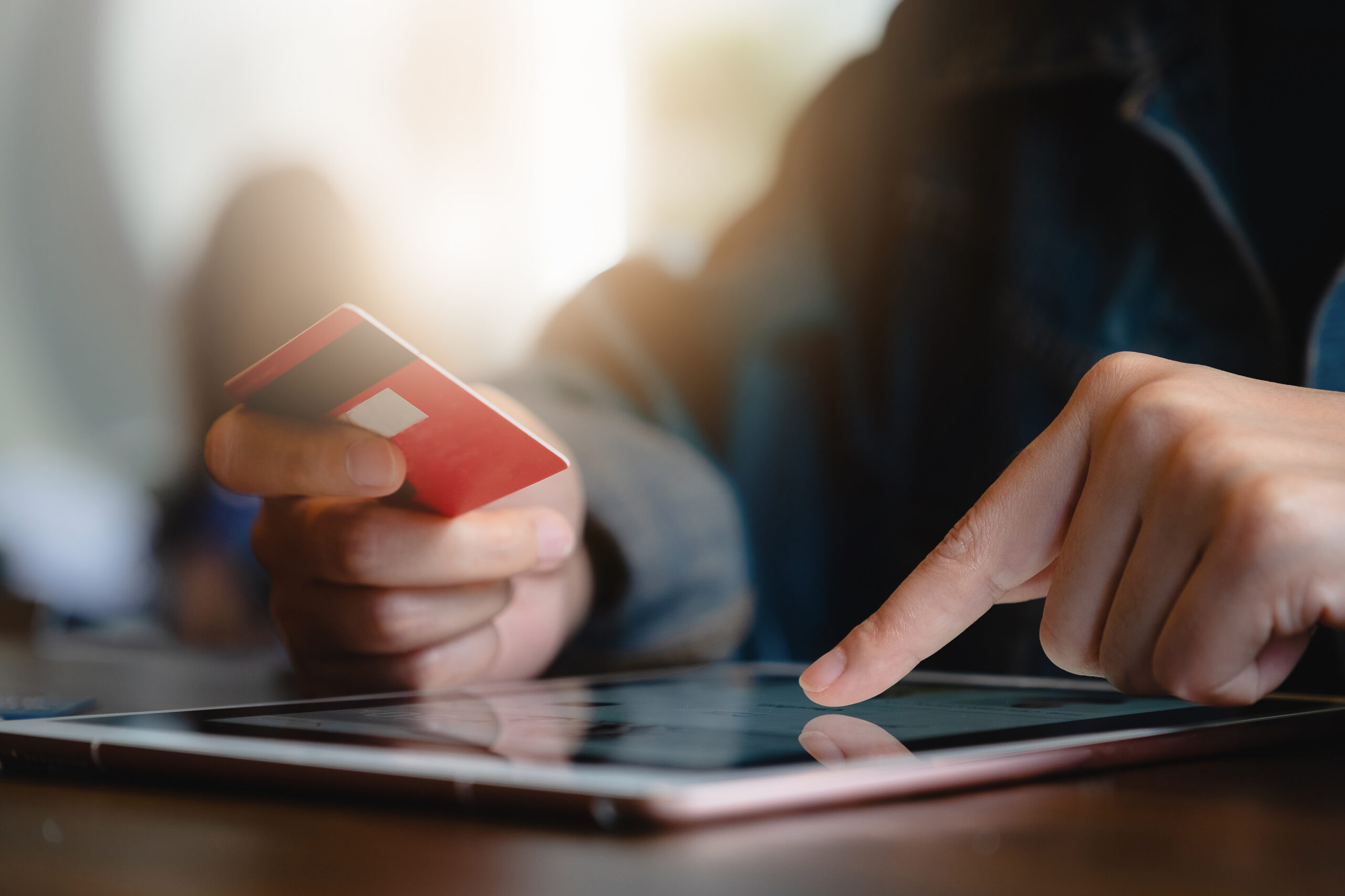 A customer makes a payment online with a credit card. FPX and e-wallets don’t replace cards.