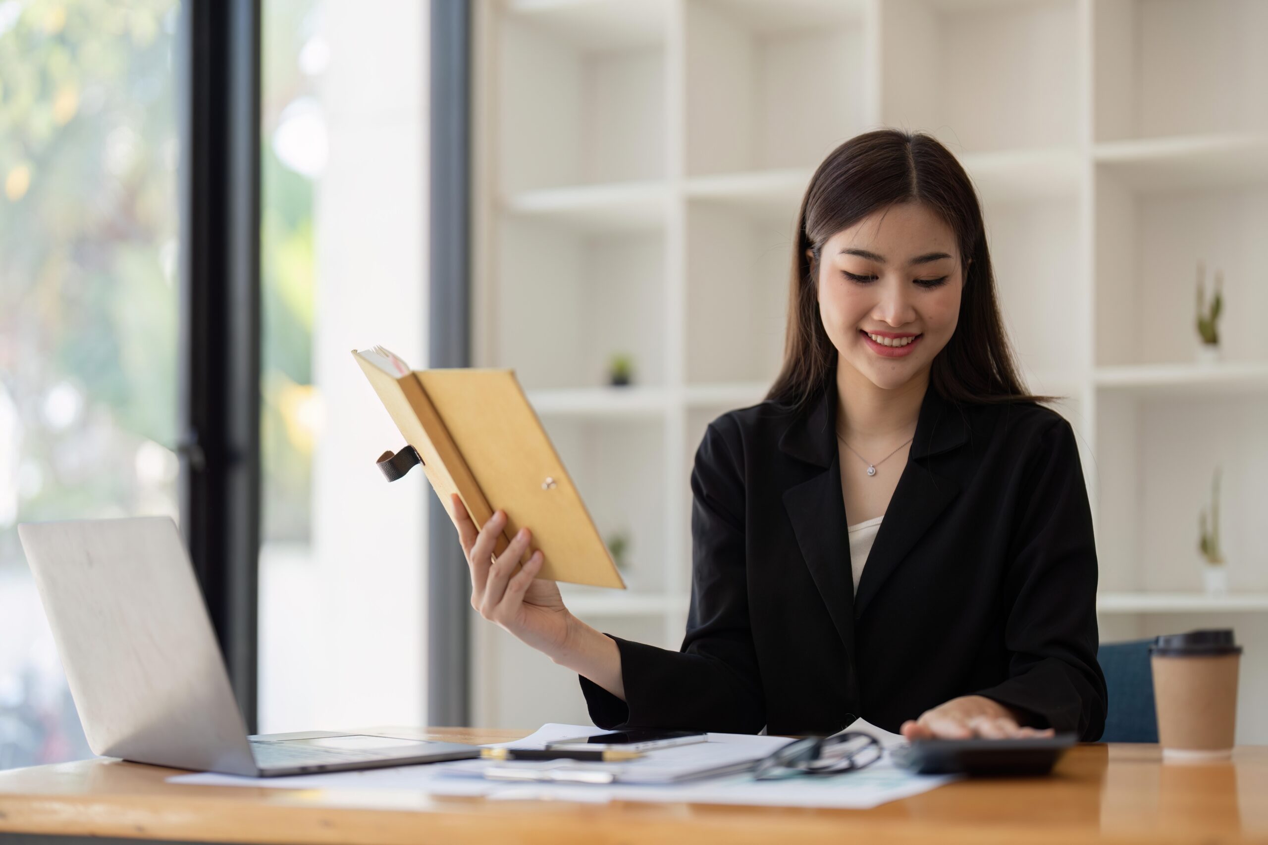 A businesswoman handling invoicing for work. Invoice generators in Malaysia smoothen the process.