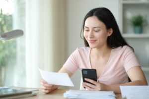 A woman pays online. Poor design decisions at checkout can be why customers abandon online payments.