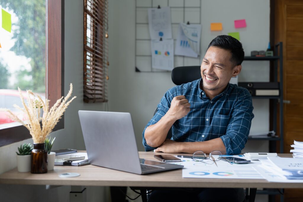 A homestay host smiles as he sees faster payment settlement for short-term rentals in Malaysia.
