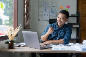 A homestay host smiles as he sees faster payment settlement for short-term rentals in Malaysia.