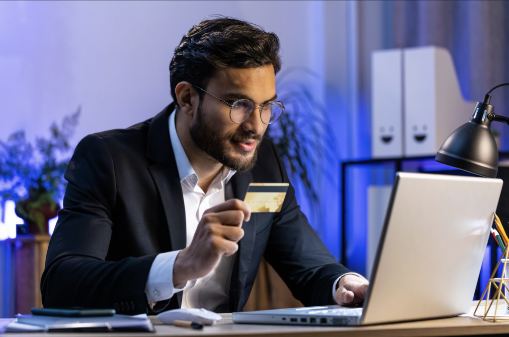 A businessman performs an online transaction. Having payment buttons for websites makes this easier.