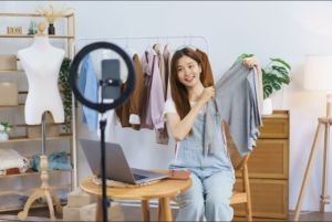 Female seller doing a live stream on Tiktok to sell clothing products