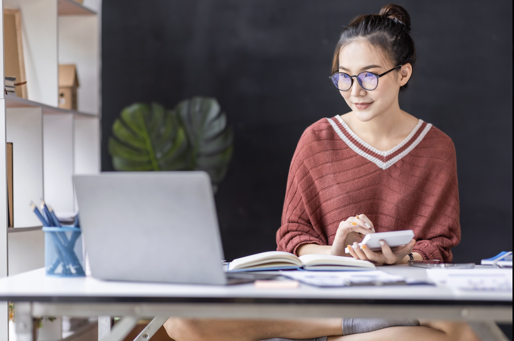 A home tutor calculates her earnings. Pay-by-link methods are ideal for this line of work.
