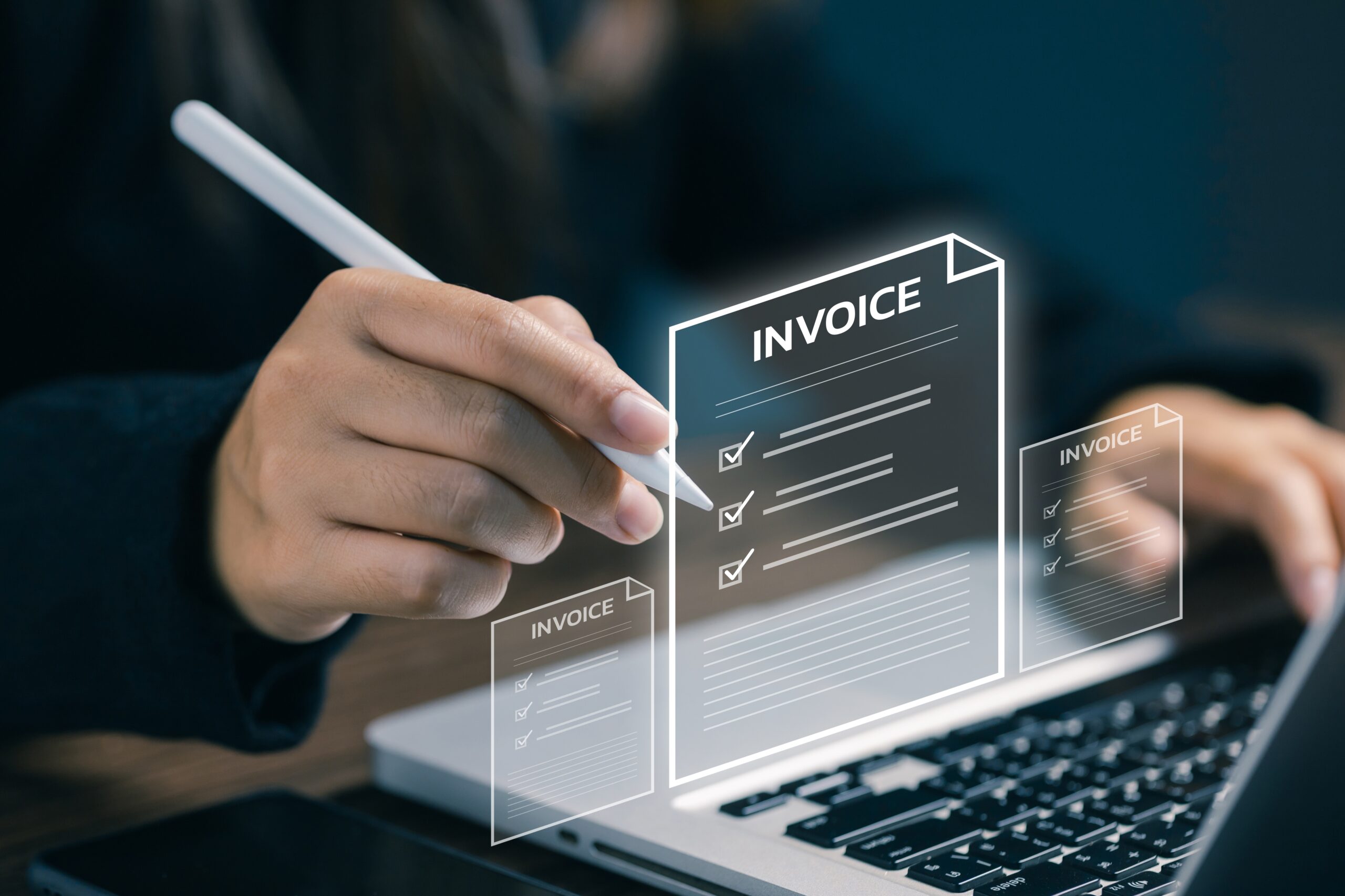 Digital invoices being created and checked on a laptop
