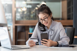 A woman makes an online payment seamlessly with a payment button built for websites and mobile.