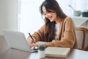 A businesswoman contemplating the cost of a payment gateway in Malaysia for her business.