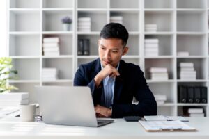 A businessman contemplating how to handle disputed payments from chargebacks in Malaysia.
