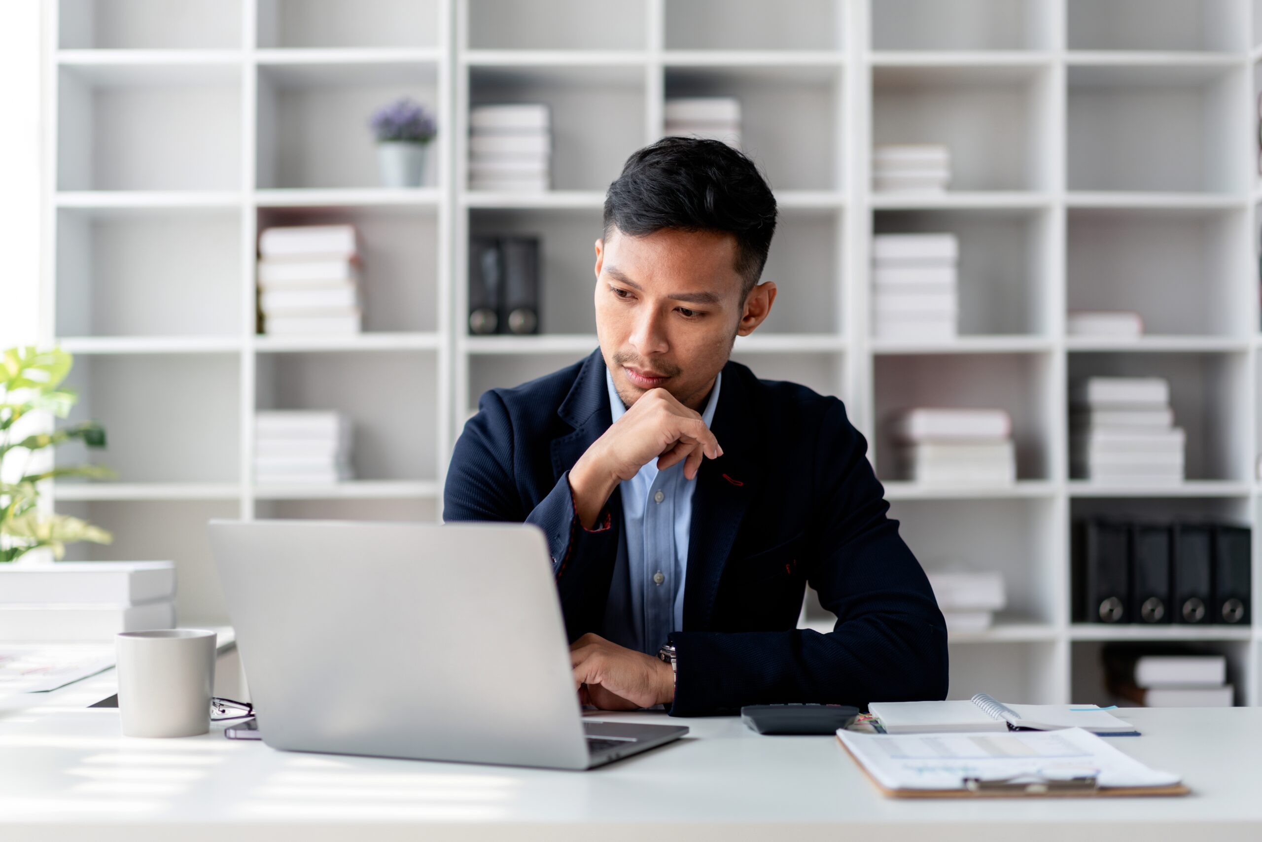 A businessman contemplating how to handle disputed payments from chargebacks in Malaysia.